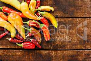 Assortment of chilli peppers on a rustic wooden table