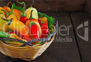 Basket of chillies on old wooden table