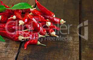 Dried red chillies on a rustic wooden table