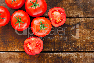 Ripe red tomatoes on old wooden table