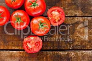 Ripe red tomatoes on old wooden table