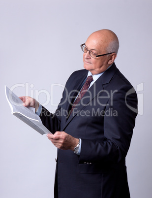 portrait of a successful senior man with book