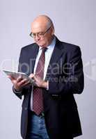 portrait of a successful senior man with tablet