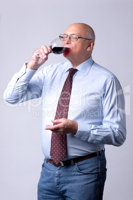 portrait of a successful senior man with glass of wine