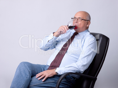 portrait of a successful senior man with glass of wine