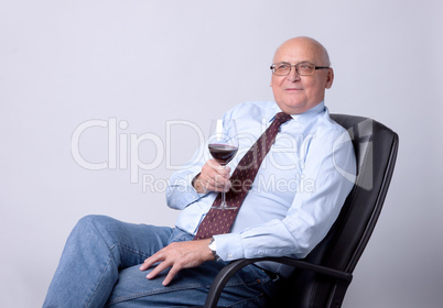 portrait of a successful senior man with glass of wine