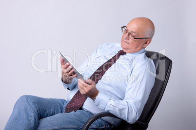 portrait of a successful senior man with tablet