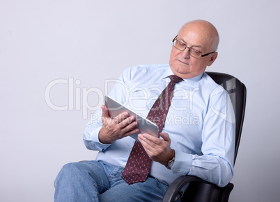 portrait of a successful senior man with tablet
