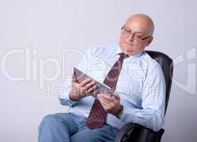 portrait of a successful senior man with tablet