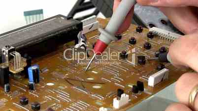 Technician probes circuit board