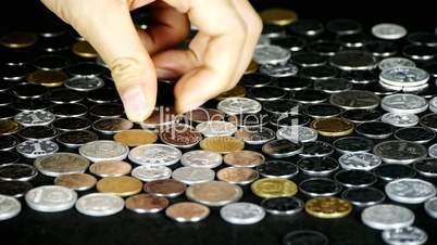 Counting golden coin from a group of money by hand.