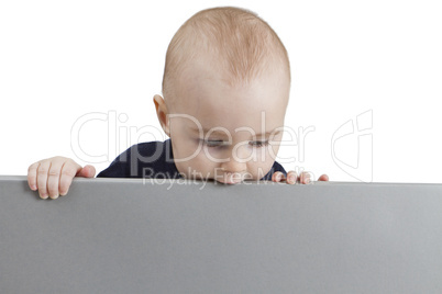 young child holding sign