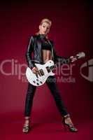 Sexy rock woman in black leather play on guitar