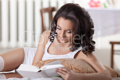 young woman read book in morning interior