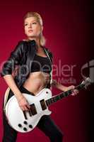 Sexy rock woman in black leather play on guitar
