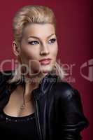 Beauty singer in black leather on red portrait