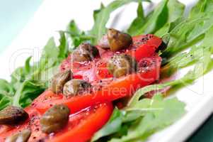 Salad with fresh tomatoes, capers and arugula