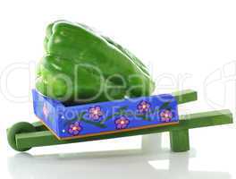 decorative blue wheelbarrow with green pepper