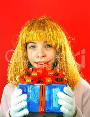 Teen girl with a present against red background
