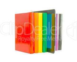 Row of colorful books and electronic book reader over white back