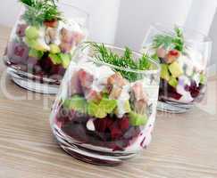 Appetizer in a glass of beet and herring with avocado