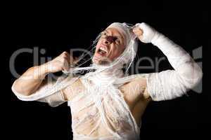 Bandaged young man in studio on black backgrund