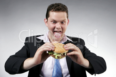 Businessman anxious to eat his hamburger