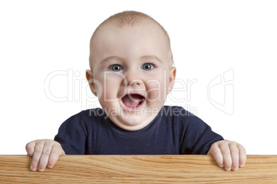 young child holding wooden board