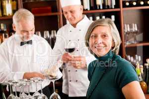 Restaurant manager with staff at wine bar
