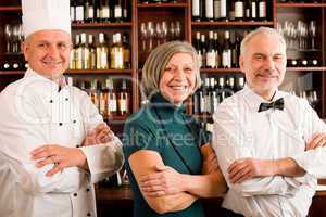 Restaurant manager posing with professional staff