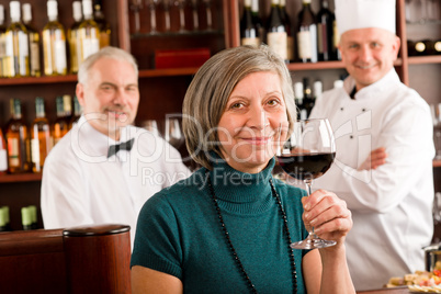 Restaurant manager taste glass red wine bar