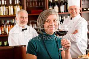 Restaurant manager taste glass red wine bar