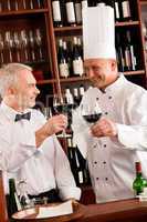 Chef cook and waiter wine tasting restaurant