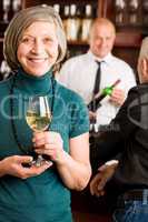 Wine bar senior woman barman discussing
