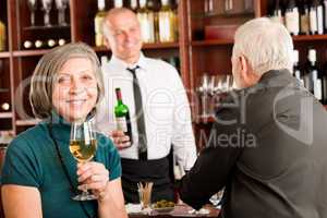 Wine bar senior couple barman discussing