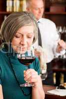 Wine bar senior woman taste wine glass