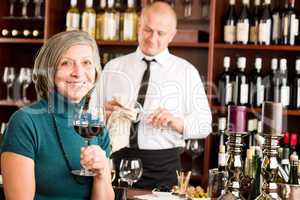 Wine bar senior woman enjoy wine glass