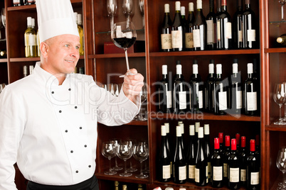 Chef cook hold wine glass in restaurant