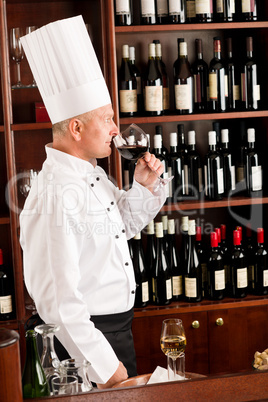 Chef cook smell wine glass in restaurant