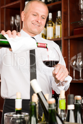 Wine bar waiter pour glass in restaurant