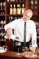 Wine bar waiter pour glass in restaurant