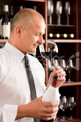 Bar waiter smell glass red wine restaurant