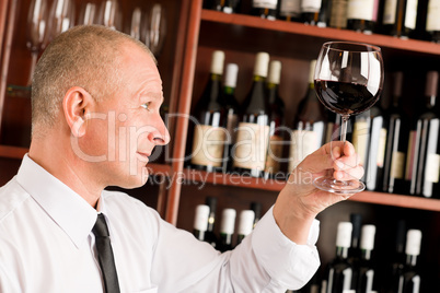 Wine bar waiter looking at glass restaurant