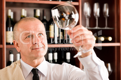 Wine bar waiter clean glass looking at