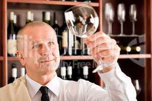 Wine bar waiter clean glass looking at