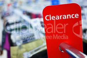 Sale Clearance Sign On Rail in Clothes Shop