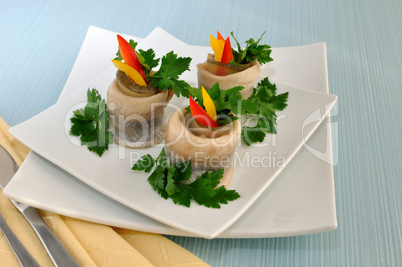 Rolls of herring with pickled cucumber and pepper