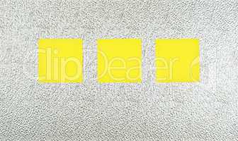 Three yellow notes on silver marbled metal plate