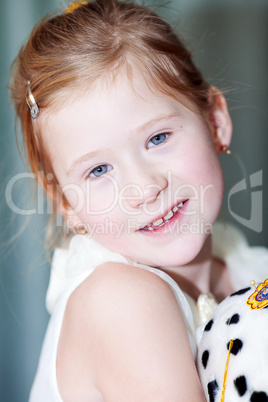 portrait of a beautiful little girl with a toy dog