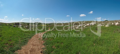 Hiking trail among Mediterranean hills in spring